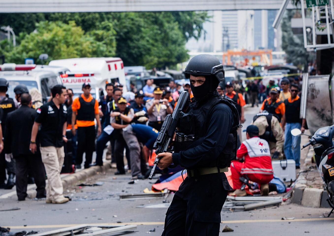 An Indonesian policeman stands guard in front of a blast site at the Indonesia capital Jakarta on January 14, 2016 in Jakarta, Indonesia. Reports of explosions and gunshots in the centre of the Indonesian capital, including outside the United Nations building and in the front of the Sarinah shopping mall, an area with many luxury hotels, embassies and offices.