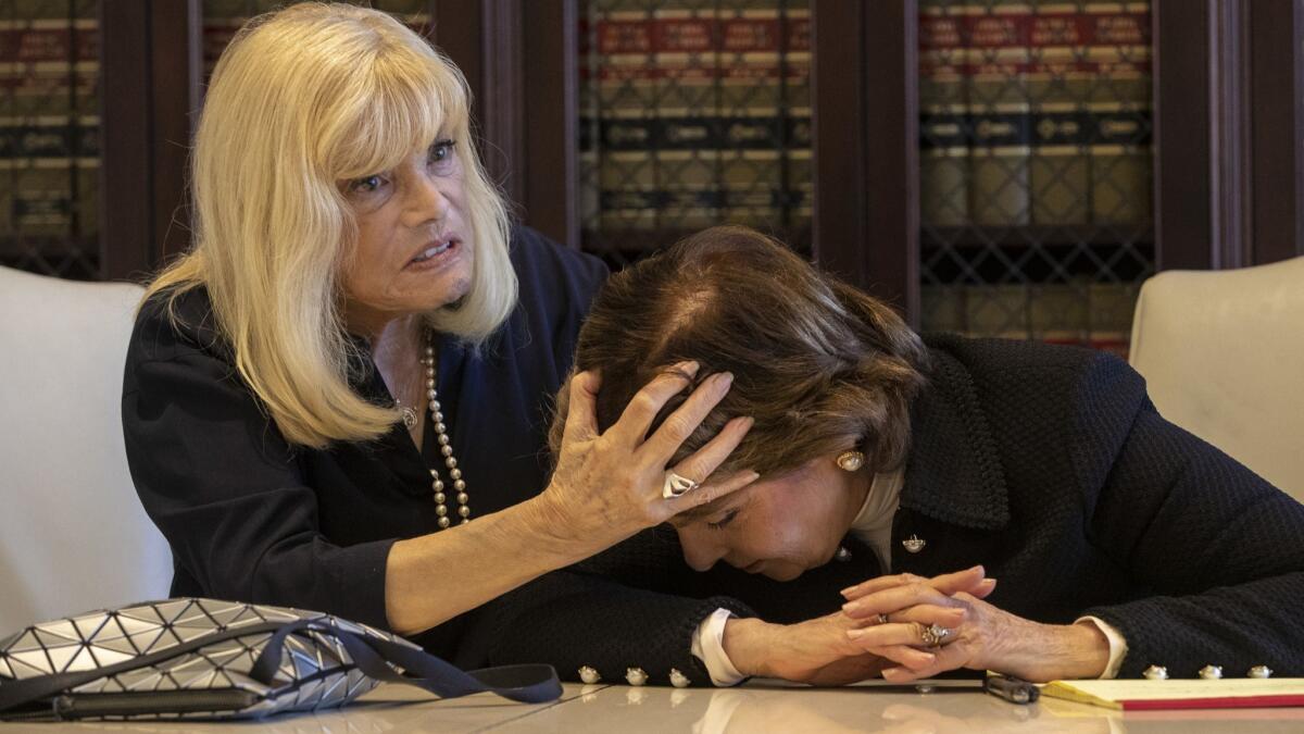 Phyllis Golden-Gottlieb demonstrates an alleged encounter with former CBS Corp. Chief Leslie Moonves in 1986 with her attorney Gloria Allred. Golden-Gottlieb alleges that Moonves thrust her head into his lap.