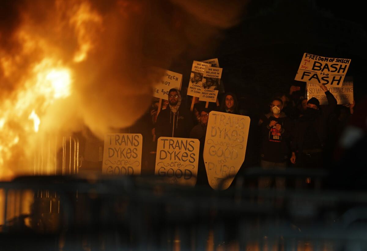 Protesters watch a fire at Berkeley's Sproul Plaza during a rally in February against a scheduled appearance by far-right commentator Milo Yiannopoulos.