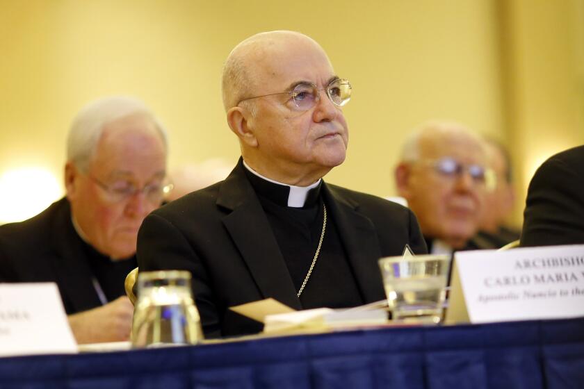 FILE - Archbishop Carlo Maria Vigano, Apostolic Nuncio to the U.S., listens to remarks at the U.S. Conference of Catholic Bishops' annual fall meeting in Baltimore, Nov. 16, 2015. The Vatican has excommunicated its former ambassador to the U.S., Archbishop Carlo Maria Viganò, after finding him guilty of schism, an inevitable end for the firebrand conservative who became one of Pope Francis' most ardent critics. (AP Photo/Patrick Semansky, File)
