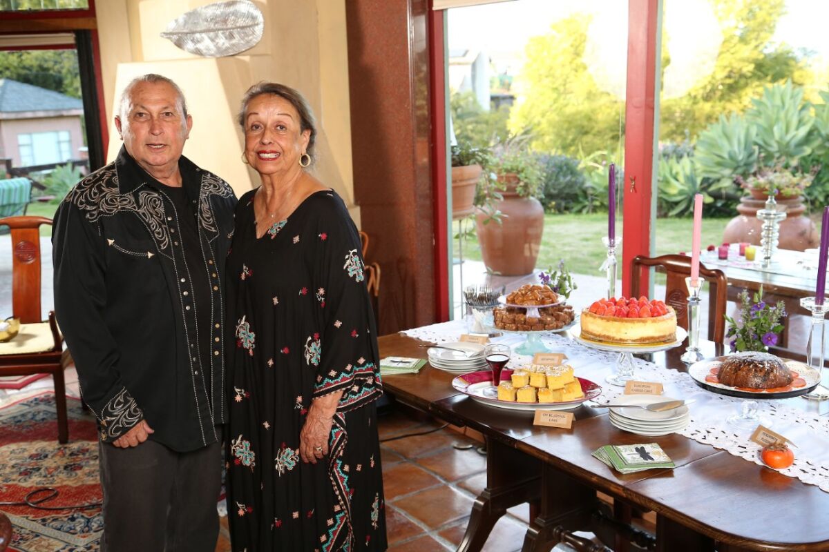 Epi and Virginia Tapia showing some of the dishes featured in "Epi’s ABCD Cookbook – Already Been Cooked and Done."