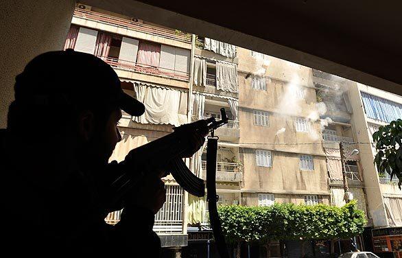 A Shiite gunman fires his AK-47 during a gunbattle in a Beirut neighborhood. The Shiite militia Hezbollah seized control of much of the Lebanese capital in clashes reminiscent of the country's 15-year civil war.