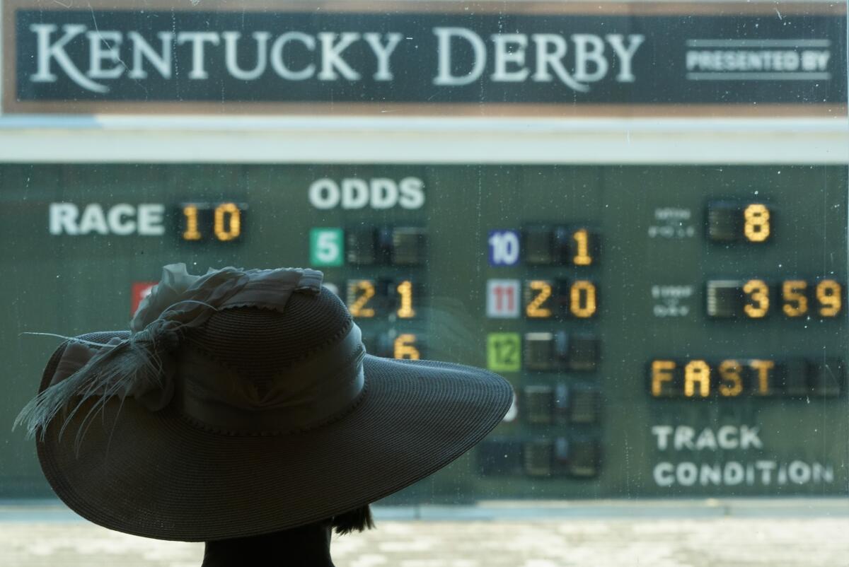 A guest looks out over the paddock before the 146th running of the Kentucky Derby at Churchill Downs.