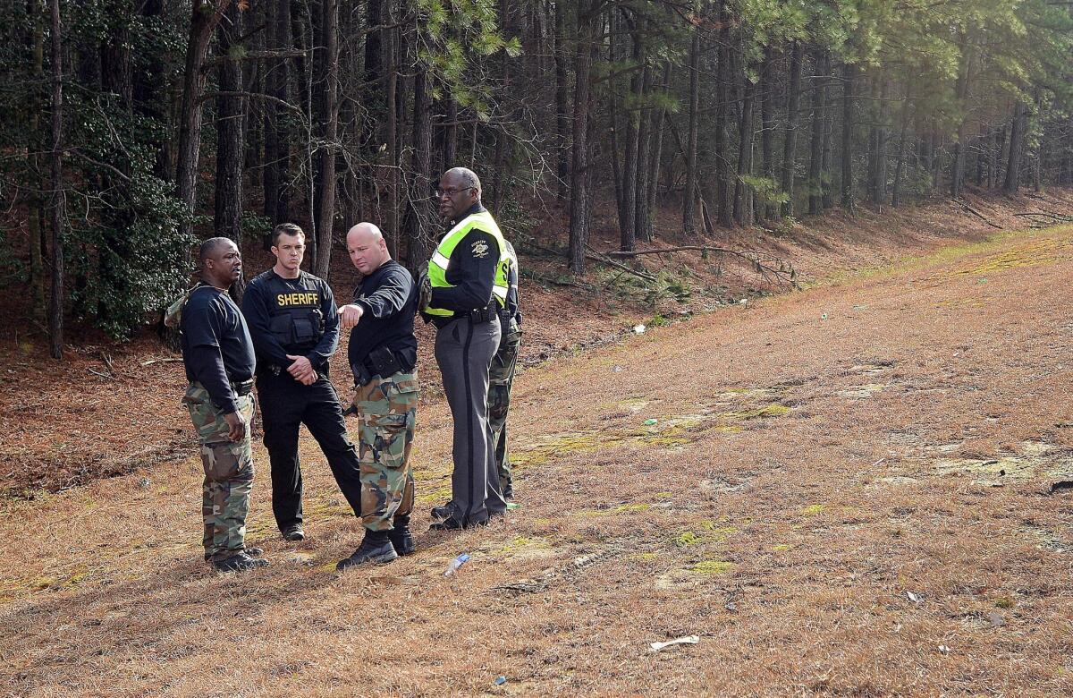 The day after armed men stole $4 million worth of gold from a truck, Wilson County sheriff's deputies investigate the area near Interstate 95 in North Carolina.