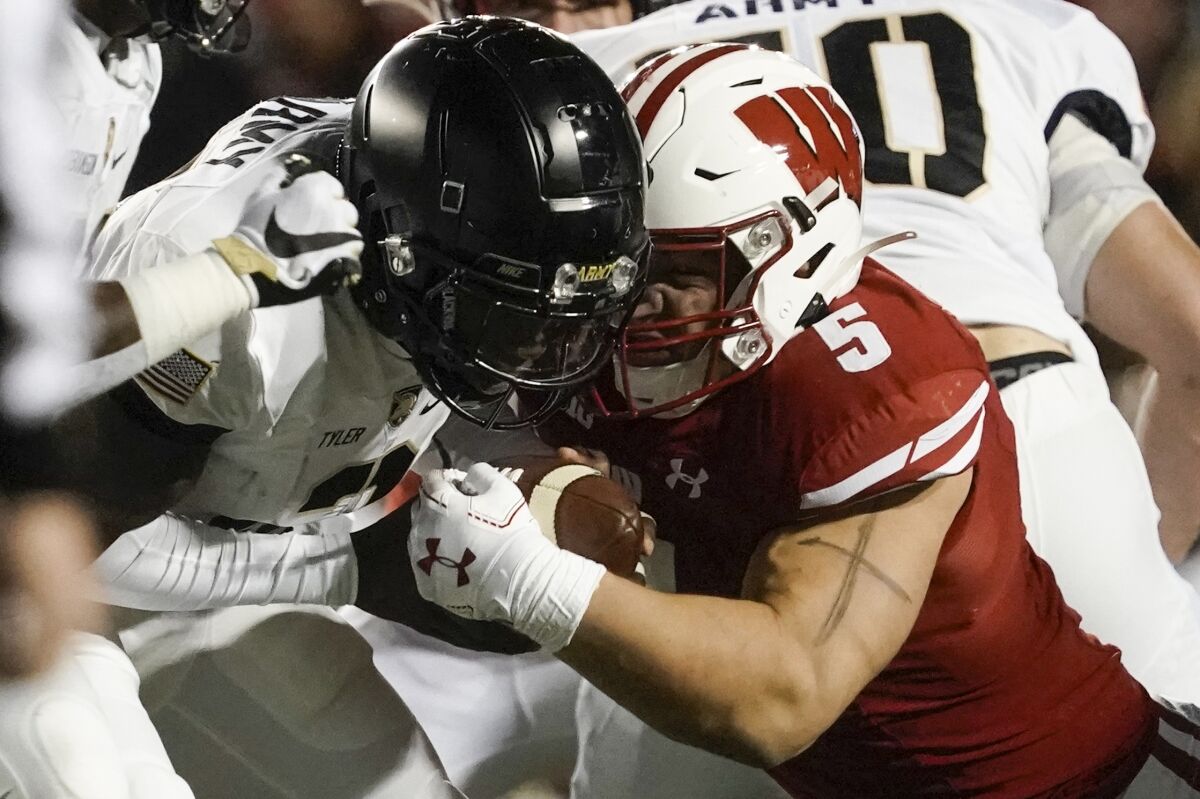 Wisconsin's Leo Chenal hits Army's Tyhier Tyler for a loss during the first half of an NCAA college football game Saturday, Oct. 16, 2021, in Madison, Wis. (AP Photo/Morry Gash)