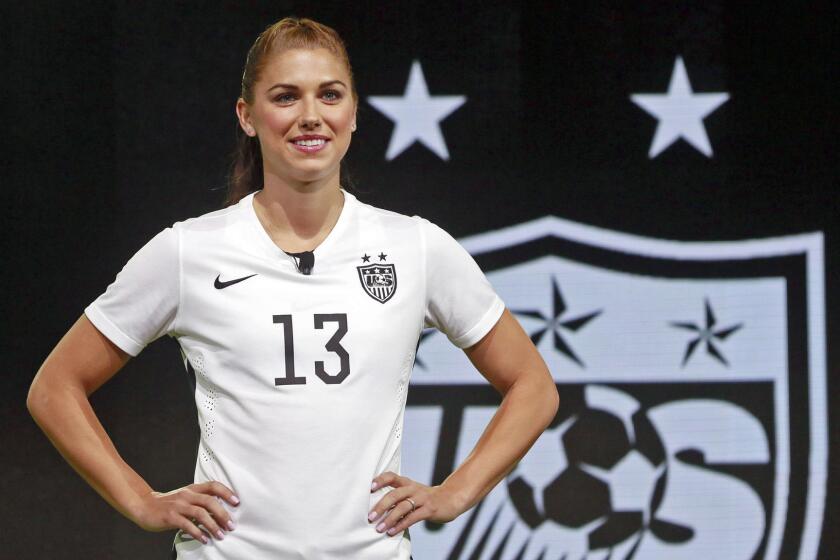 U.S. forward Alex Morgan shows off the new black and white uniforms the team will wear during the Women's World Cup in Canada in June.