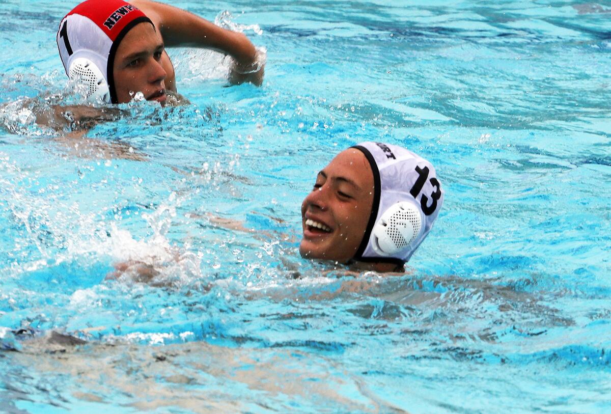 Newport Harbor's Kai Kaneko (13) smiles after scoring at the buzzer against Corona del Mar on Saturday.