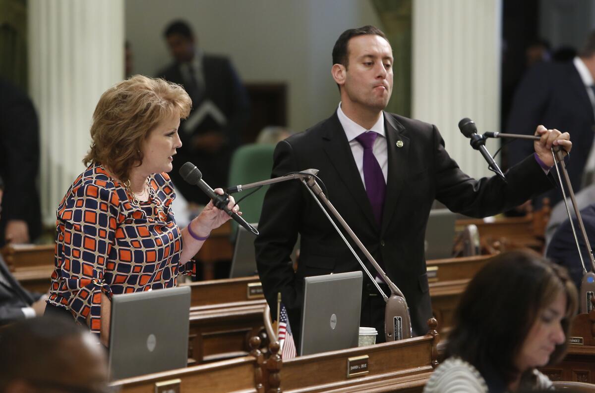 The legal troubles of Assemblyman Roger Hernandez (D-West Covina), shown in September 2013, have become a political headache for Assembly Democrats. At left is Assemblywoman Shannon Grove (R-Bakersfield).