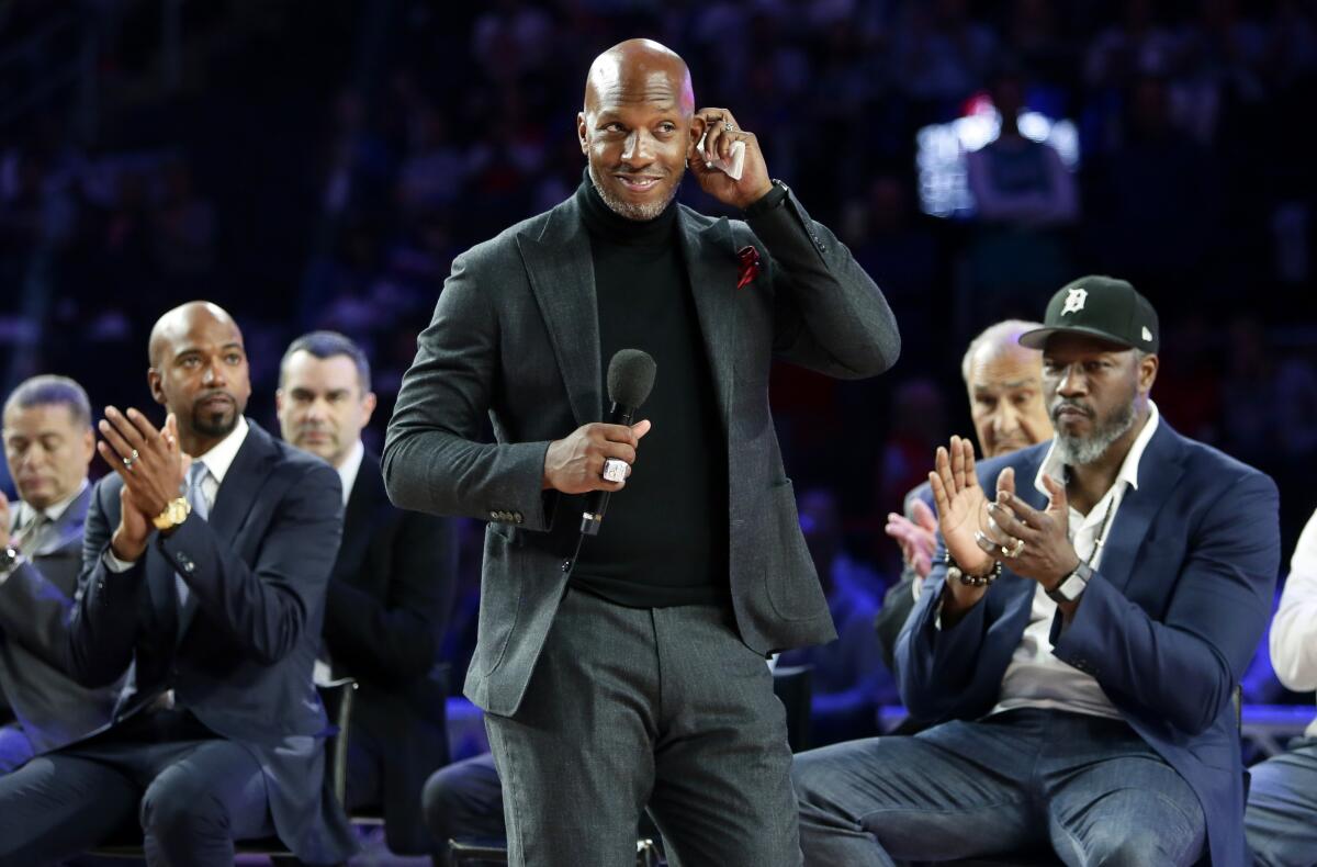Chauncey Billups, center, addresses fans during a ceremony in Detroit.