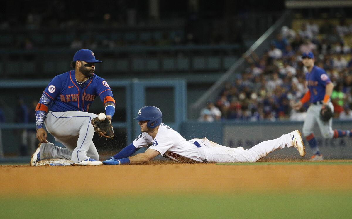 Dodgers shortstop Trea Turner steals second base as New York Mets second baseman Jonathan Villar gets a late throw.