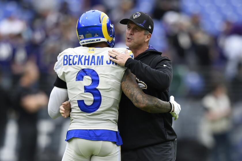 Los Angeles Rams wide receiver Odell Beckham Jr. (3) talks with Baltimore Ravens head coach John Harbaugh prior to an NFL football game, Sunday, Jan. 2, 2022, in Baltimore. (AP Photo/Gail Burton)