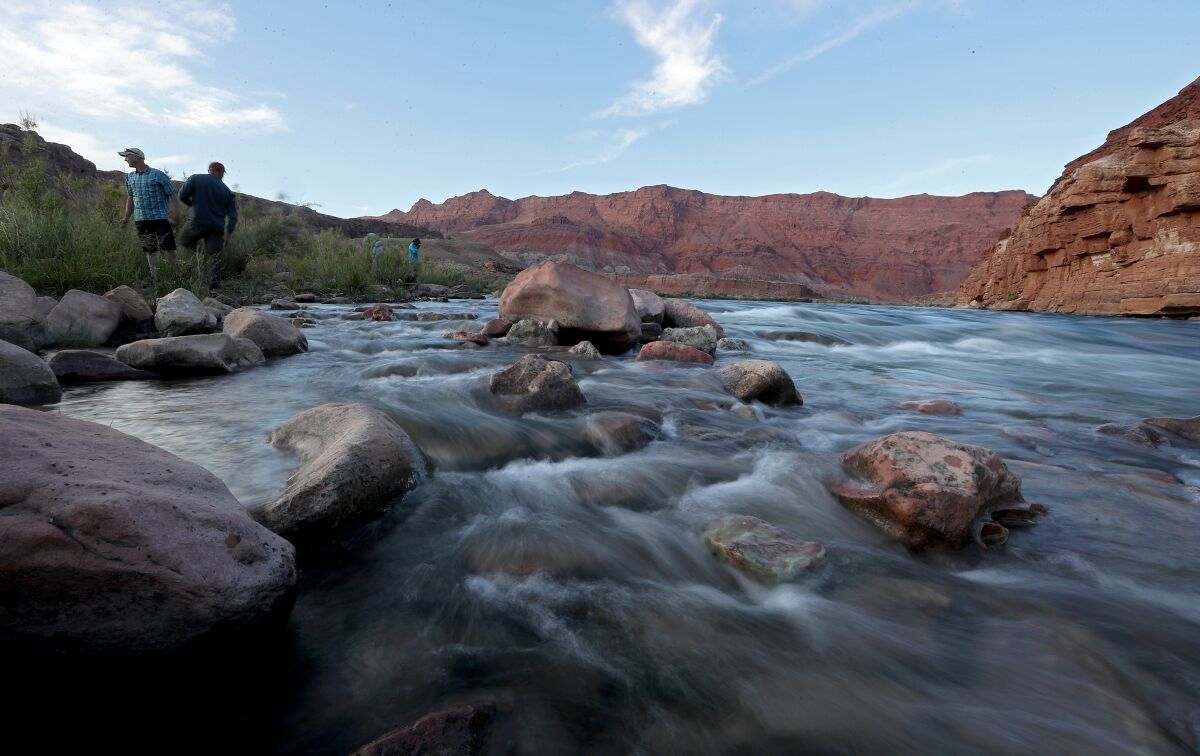 Water flows over rocks along the Colorado River.