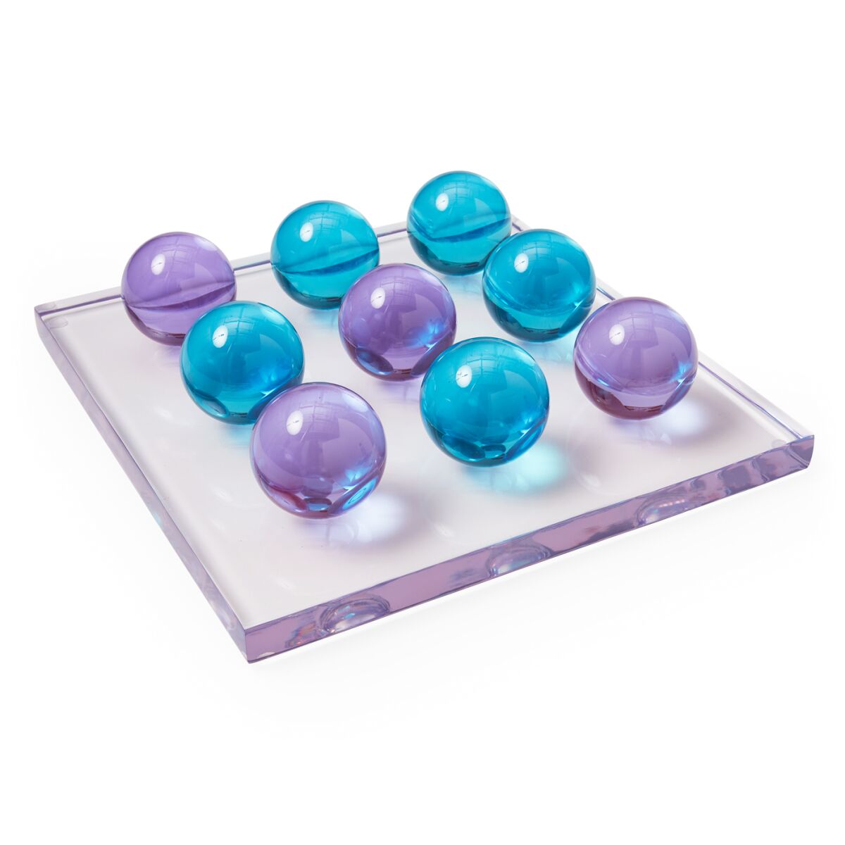 Turquoise and purple playing pieces on a thick slab of clear acrylic. 