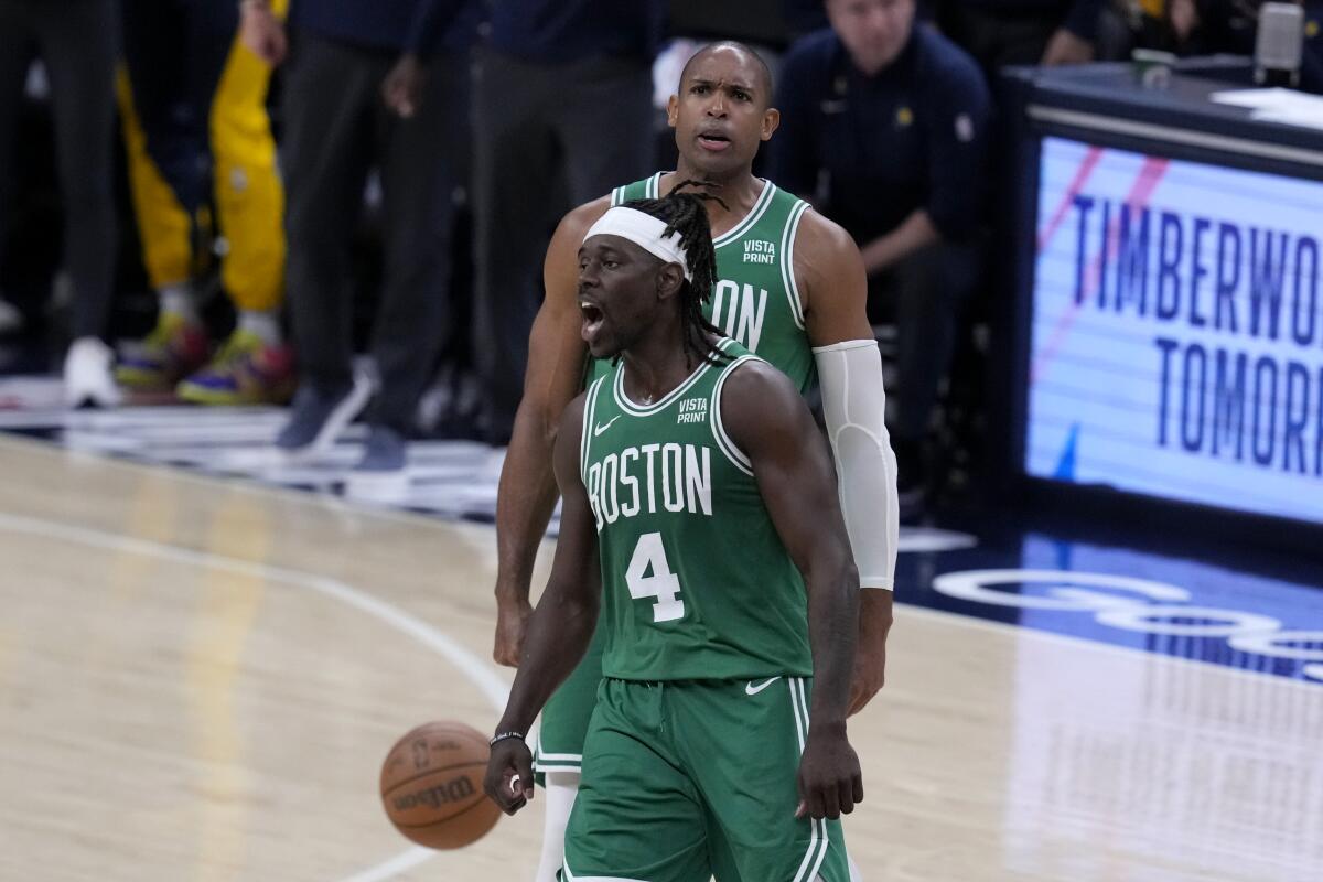 Boston Celtics guard Jrue Holiday (4) celebrates with teammate Al Horford during the second half of a 114-111 victory.