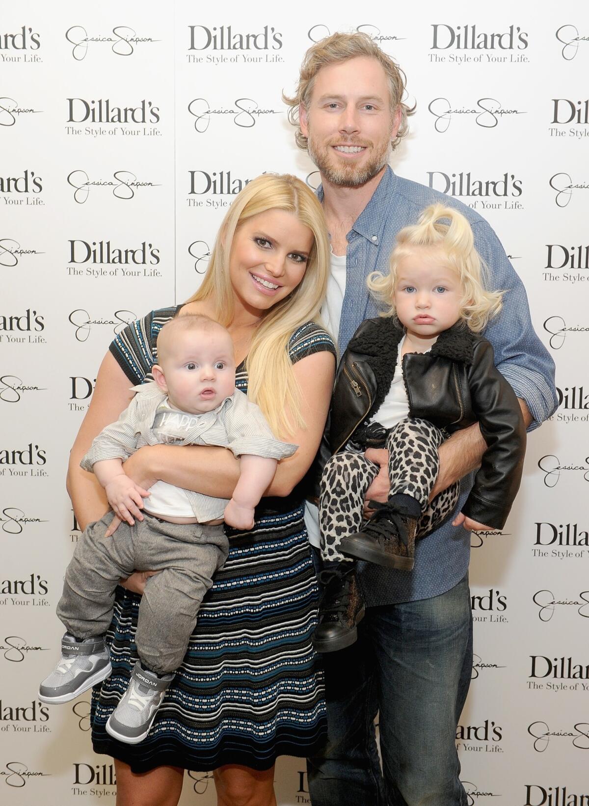 Jessica Simpson shows off her family at a Jessica Simpson Collection event at Dillard's in Dallas last month. From left are baby Ace Johnson, Simpson, her fiance Eric Johnson and toddler Maxwell Johnson.