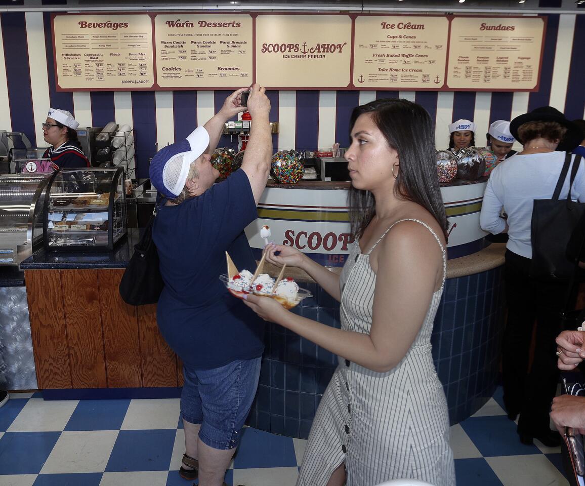 People taking pictures and carrying away serving boats of ice cream at Baskin Robbins, transformed into an 80s-era replica of an ice cream shop called Scoops Ahoy in Burbank on Tuesday, July 2, 2019. Scoops Ahoy Ice Cream Parlor will be featured in the third season of the Netflix program Stranger Things.