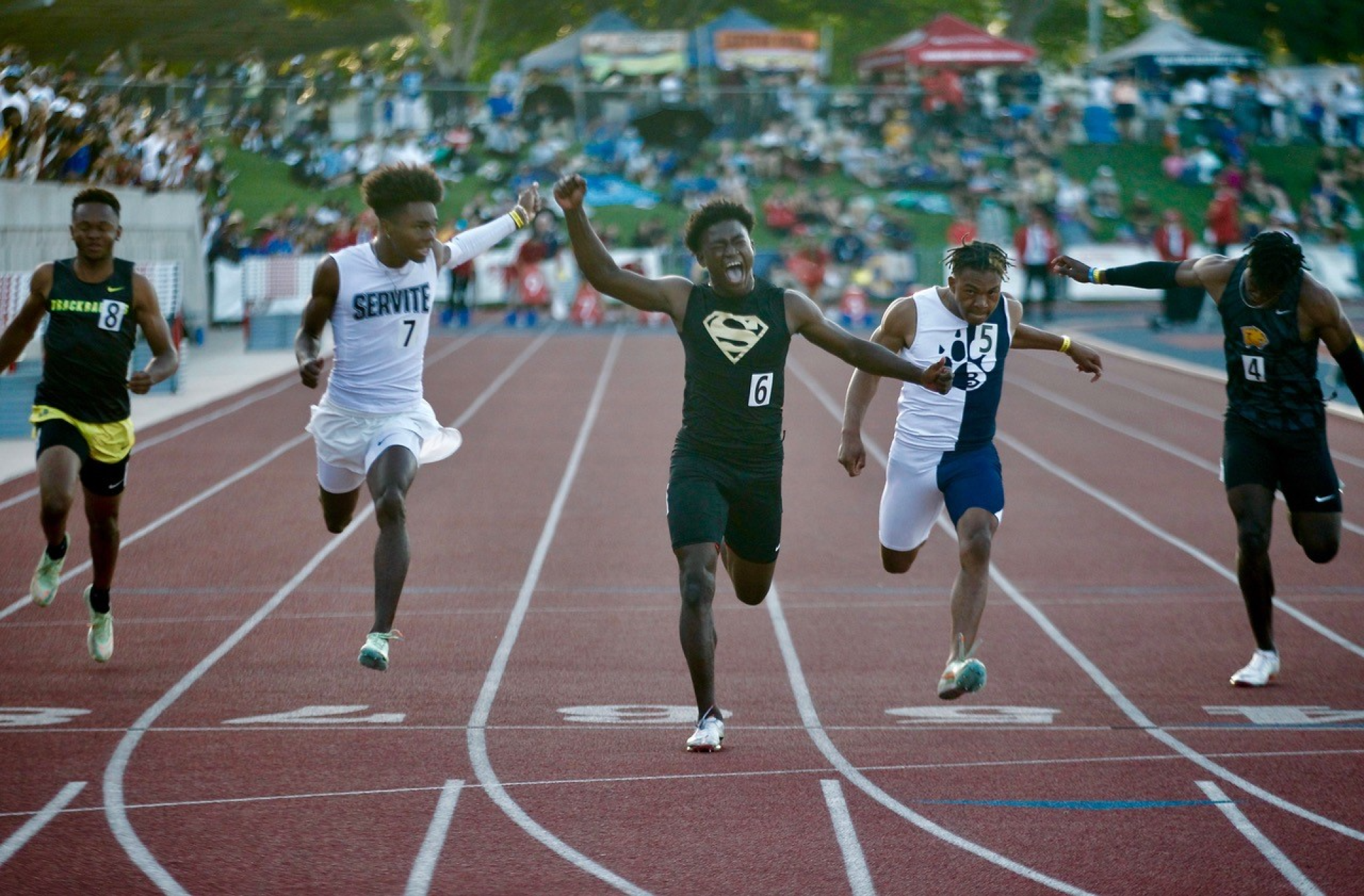 Gardena Serra's Roderick Pleasant, center, lets out a yell after winning the 100-meter dash at the state championships.
