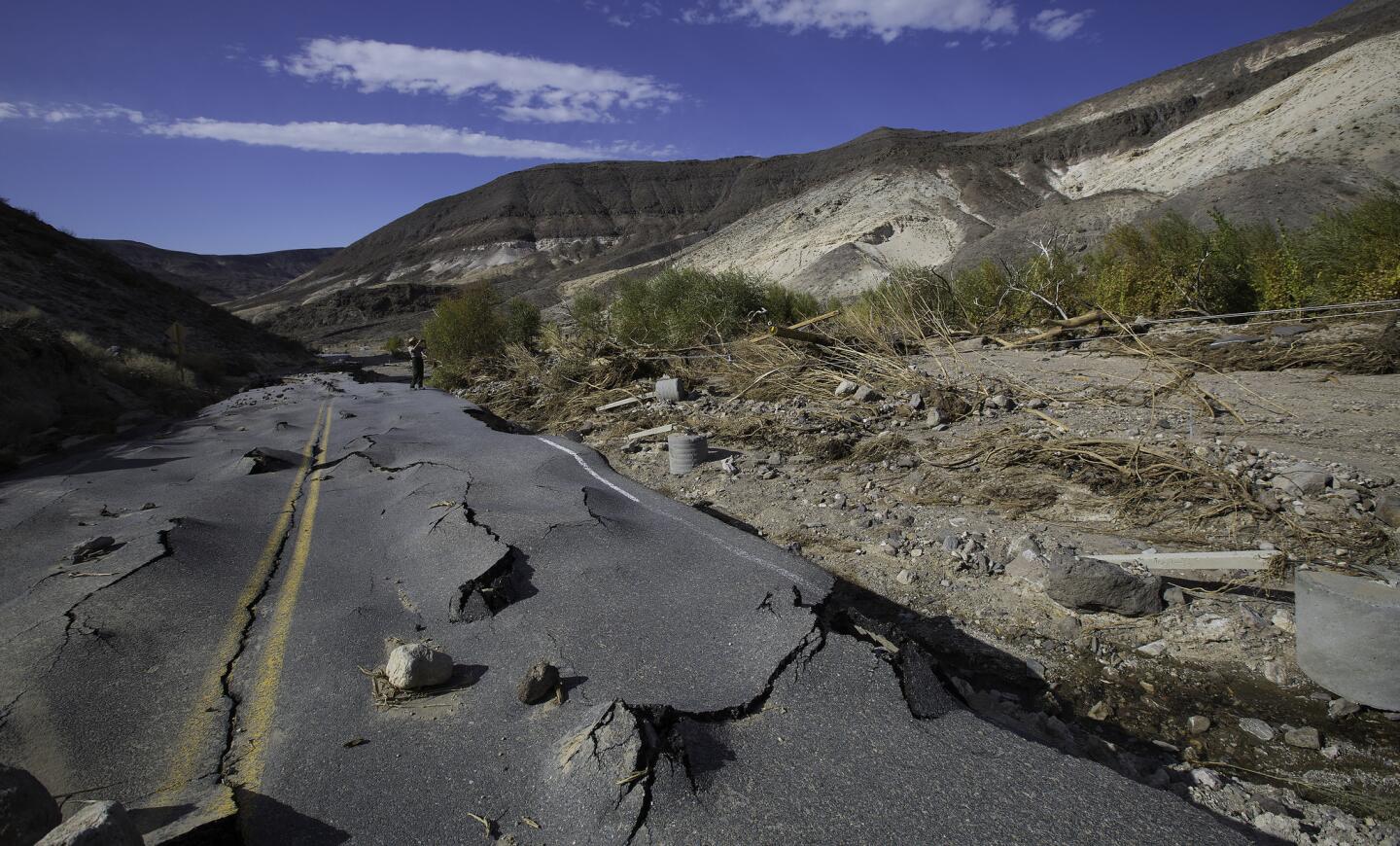 A 100-yard-long section of a newly paved Highway 267 in Grapevine Canyon, a two-lane road designed to withstand severe flooding, was lifted up by roiling water, then slammed down on boulders in Death Valley National Park.