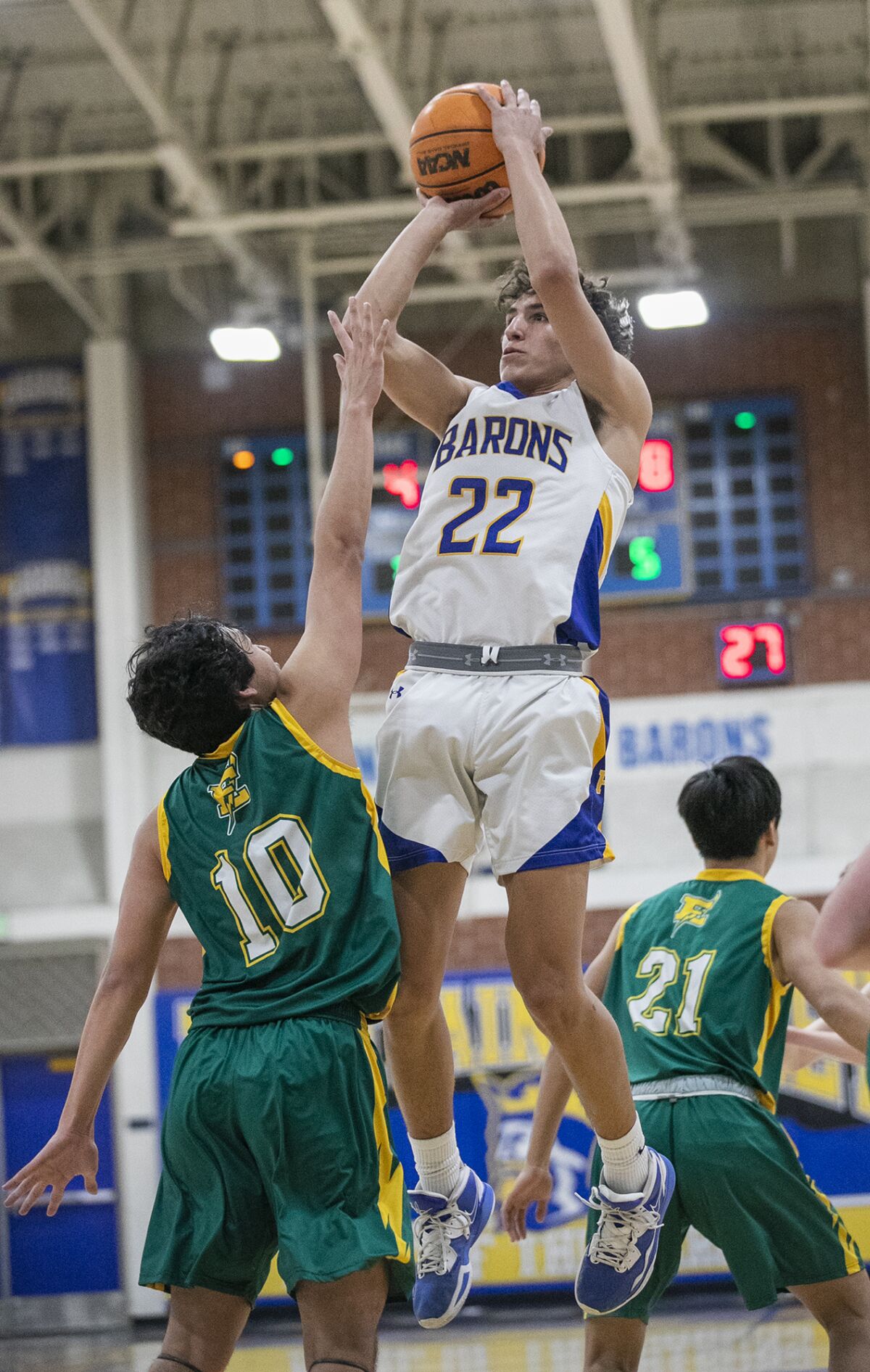 Fountain Valley's Devin Payne goes up for a shot over Edison's Garin Takushi at Fountain Valley High on Thursday.