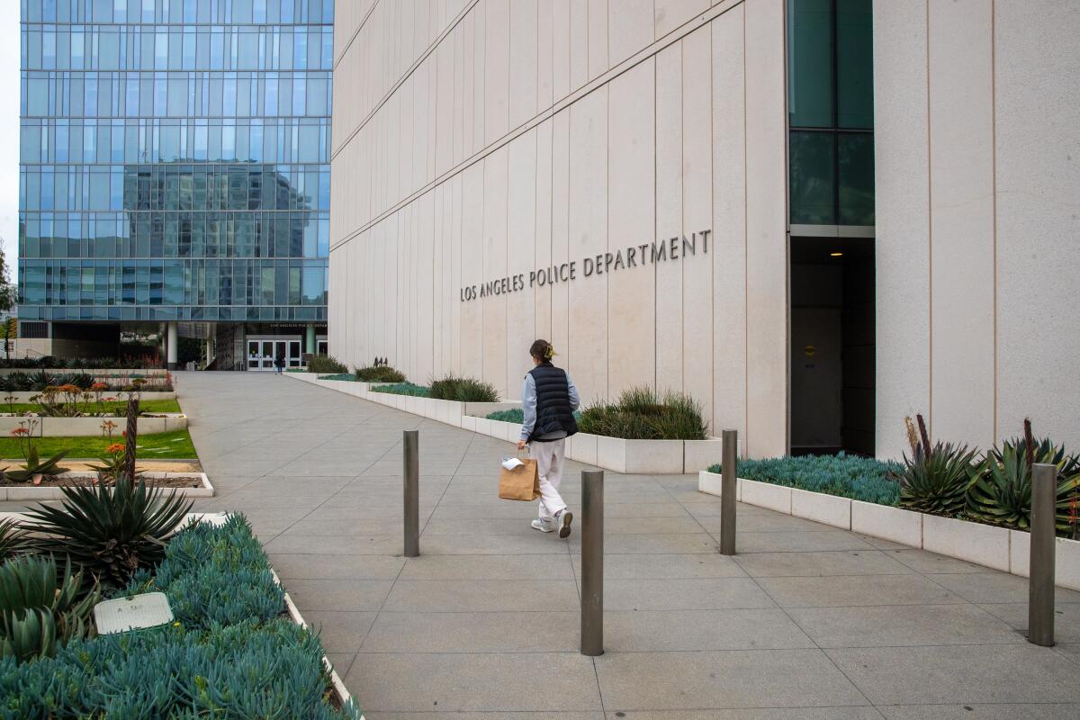 A man walks past Los Angeles Police Department headquarters