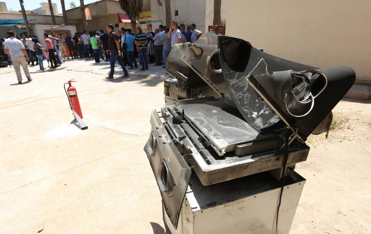 Burned incubators stand outside Yarmouk hospital in west Baghdad after an overnight fire tore through the maternity ward Aug. 10.