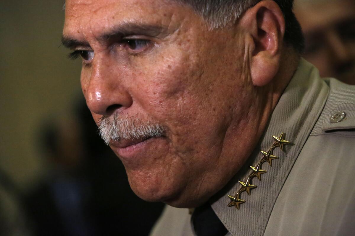 Sheriff Robert Luna wears five stars on his collar after being sworn in.