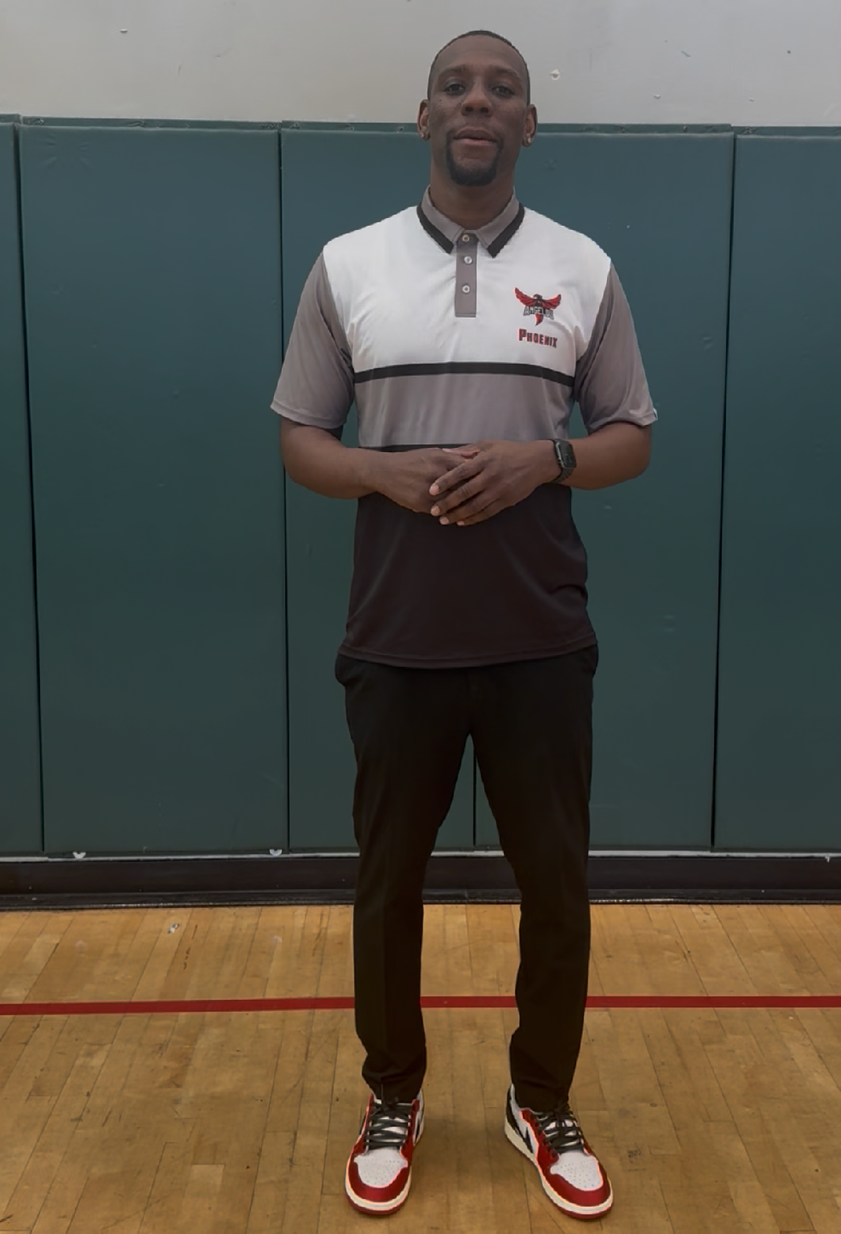 Leon Jaco poses for a photo in the Angelou High gymnasium.