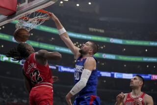 Los Angeles Clippers center Ivica Zubac (40) dunks over Chicago Bulls guard Ayo Dosunmu (12) as Bulls center Nikola Vucevic, righgt, watches during the first half of an NBA basketball game in Los Angeles, Saturday, March 9, 2024. (AP Photo/Eric Thayer)