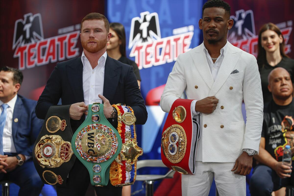 WBC and WBA middleweight world champion Canelo Alvarez (50-1-2, 34 KOs), left, and IBF middleweight world champion Daniel Jacobs (35-2, 29 KOs), right, pose with their title belts during a pre-fight press conference in Mexico City, Friday March 1, 2019. Alvarez and Jacobs meet in a 12-round unification bout in Las Vegas, on Saturday May, 4, 2019.