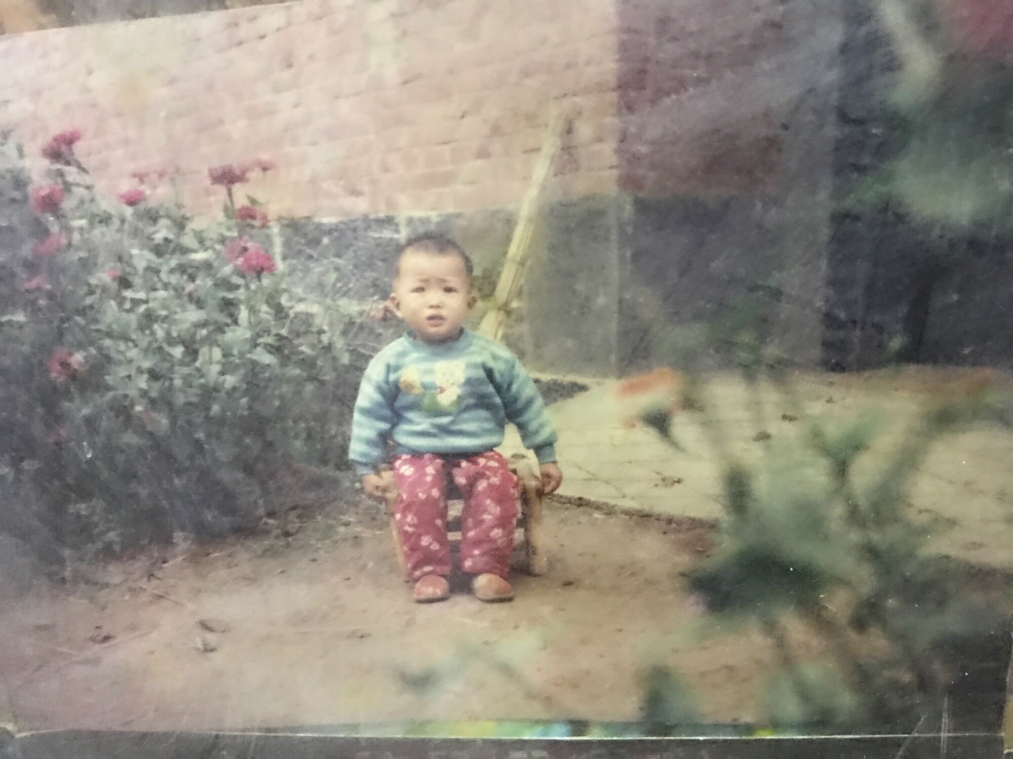 An old photo of a baby outside