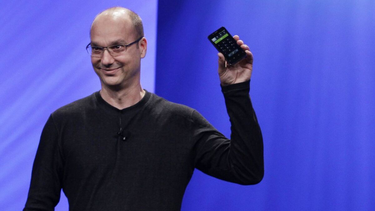 Google's then-senior vice president of mobile, Andy Rubin, holds up a Google Android phone at the Intel Developer Forum in San Francisco on Sept. 13, 2011.
