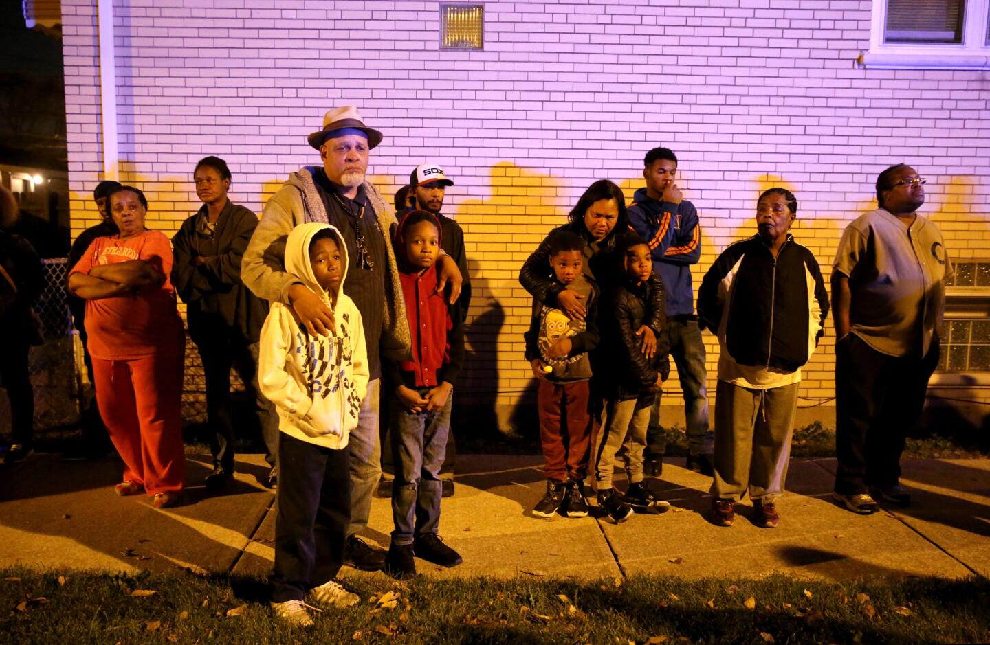 Auburn Gresham neighborhood community residents listen during an Operation: Wake Up! event put on by the Chicago Police Department on the 8000 block of South Damen Avenue on Nov. 3, 2015. Tyshawn Lee, 9, was shot and killed in a nearby alley on Monday.