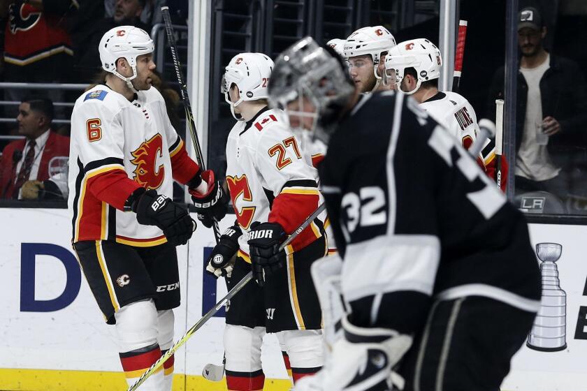 Calgary Flames players celebrate their goal against the Los Angeles Kings during the third period of an NHL hockey game, Monday, April 1, 2019, in Los Angeles. Flames won 7-2. (AP Photo/Ringo H.W. Chiu)