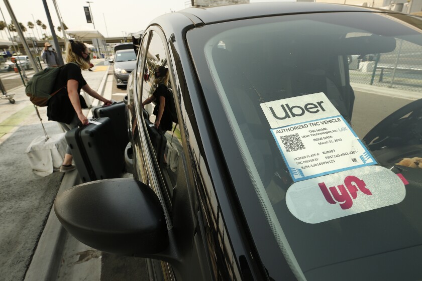 Passengers connect with drivers at the ride-hailing lot at LAX on Aug. 20.
