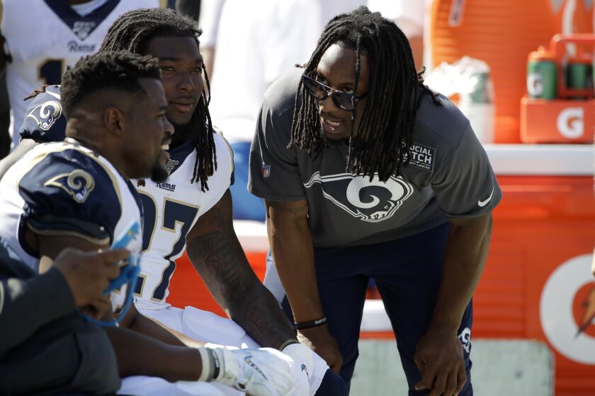 Los Angeles Rams running back Todd Gurleyr, right, talks with running back Malcolm Brown, left, and running back Darrell Henderson, center, during the first half of an NFL football game against the San Francisco 49ers Sunday, Oct. 13, 2019, in Los Angeles. (AP Photo/Alex Gallardo)