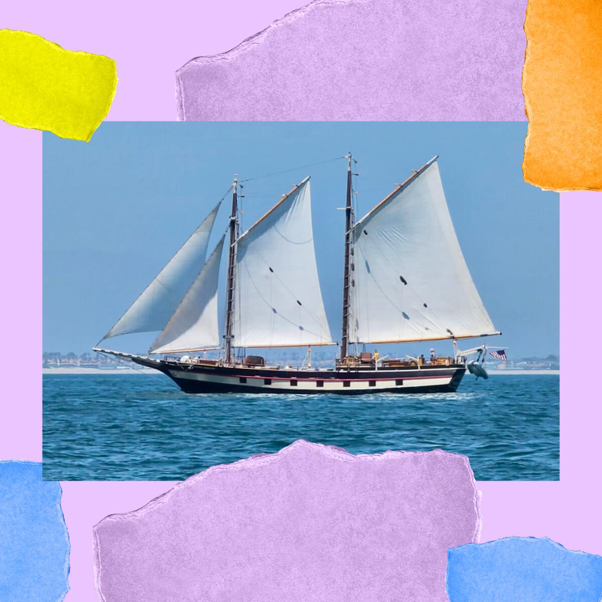 A tall ship is seen from a distance on the ocean.