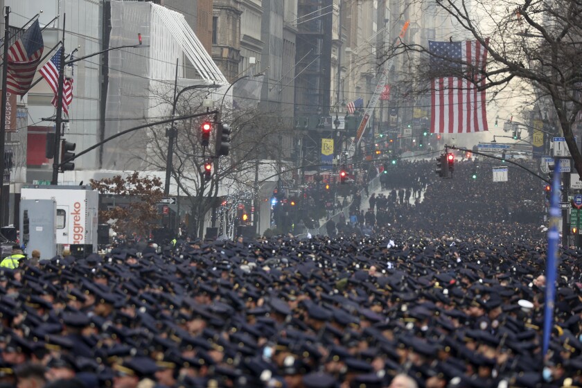 New York Police officers gather along Fifth Avenue for the funeral of Officer Jason Rivera, Friday, Jan. 28, 2022, outside St. Patrick's Cathedral in New York. Rivera and his partner, Officer Wilbert Mora, were fatally wounded when a gunman ambushed them in an apartment as they responded to a family dispute last week. (AP Photo/Yuki Iwamura)