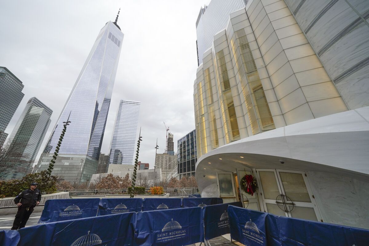 One World Trade, left, is seen next to St. Nicholas Greek Orthodox Church in New York, Tuesday, Dec. 6, 2022. After a rebuilding process that lasted more than two decades, the Greek Orthodox church that was destroyed in the Sept. 11 attacks has reopened at the World Trade Center site. The St. Nicholas Greek Orthodox Church and National Shrine, designed by architect Santiago Calatrava, now overlooks the Trade Center memorial pools from an elevated park. (AP Photo/Seth Wenig)