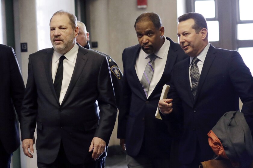 FILE — In this Jan. 25, 2019, file photo, Harvey Weinstein, left, enters court with attorneys Ron Sullivan, center, and Jose Baez, in New York. Weinstein is suing his one-time lawyer, Baez, for breach of contract and is seeking a refund on $1 million in legal fees he says he paid the high-profile attorney for a short stint on his legal team. (AP Photo/Mark Lennihan, File)