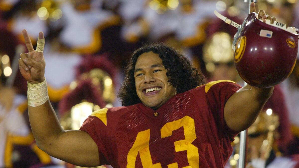 USC defensive back Troy Polamalu leads the Trojans in a victory song following a 44-13 win over Notre Dame on Nov. 30, 2002.