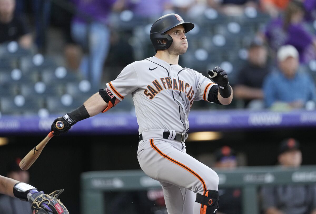 San Francisco Giants' Tommy La Stella follows the flight of his solo home run off Colorado Rockies starting pitcher Chad Kuhl in the first inning of a baseball game Tuesday, May 17, 2022, in Denver. (AP Photo/David Zalubowski)