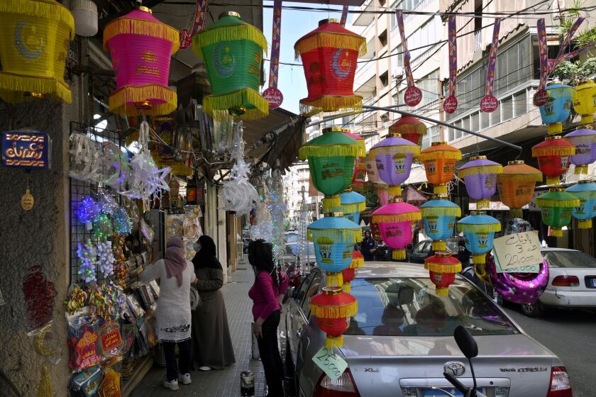 FILE - People shop for decorations for the Muslim holy month of Ramadan in Beirut, Lebanon, Saturday, April 2, 2022. Muslims throughout the world are marking Ramadan, a month of fasting during which observants abstain from food, drink and other pleasures from sunrise to sunset. (AP Photo/Bilal Hussein, File)