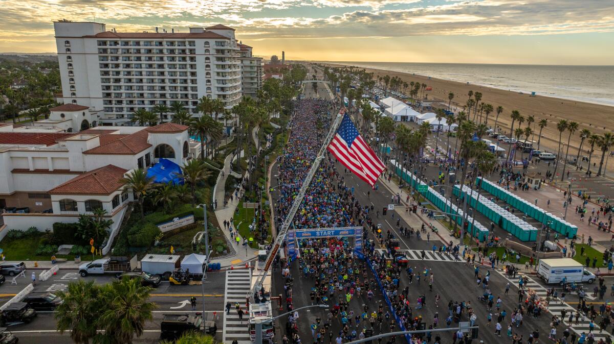 Runners line Pacific Coast Highway in Huntington Beach during Sunday's Surf City Marathon.
