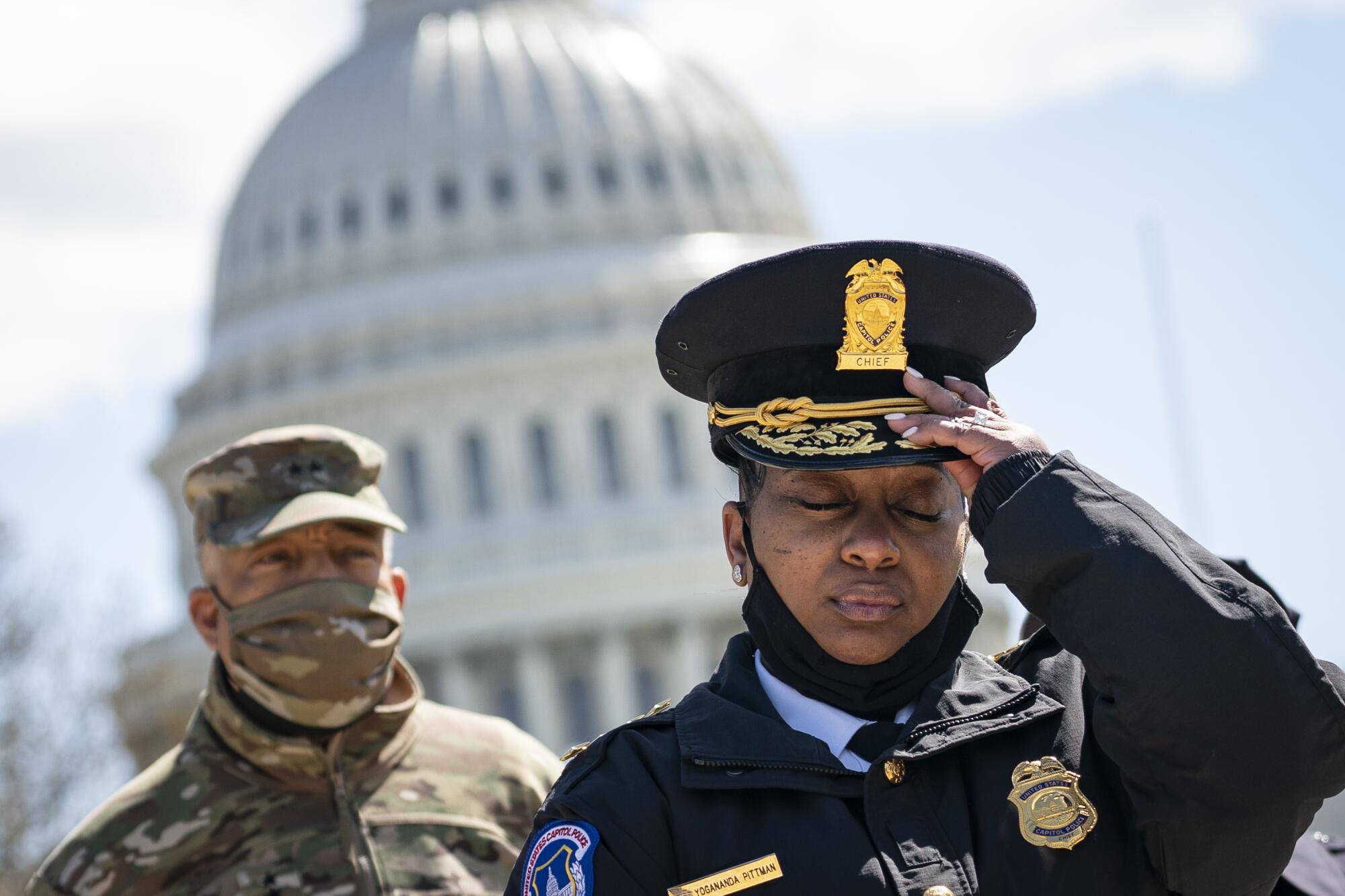 Acting Capitol Police Chief Yogananda Pittman (R) attends a press briefing about the security incident at the U.S. Capitol