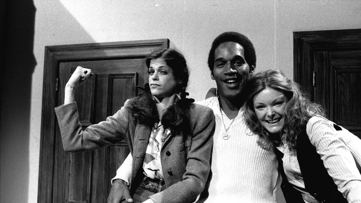 O.J. Simpson, center, poses with actresses Gilda Radner, left, and Jane Curtin while appearing on NBC's "Saturday Night Live" in 1978. (Associated Press )
