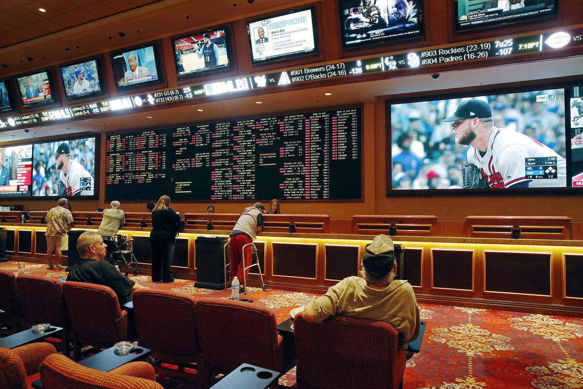 People make bets in the sports book at the South Point hotel and casino in Las Vegas in 2018. 
