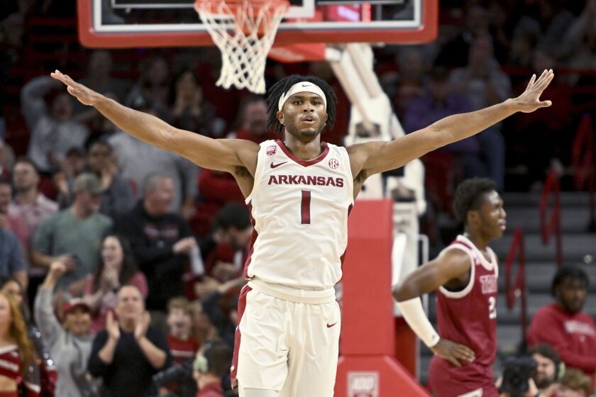 Arkansas guard Ricky Council IV (1) celebrates after scoring against Troy during the first half of an NCAA college basketball game, Monday, Nov. 28, 2022, in Fayetteville, Ark. (AP Photo/Michael Woods)