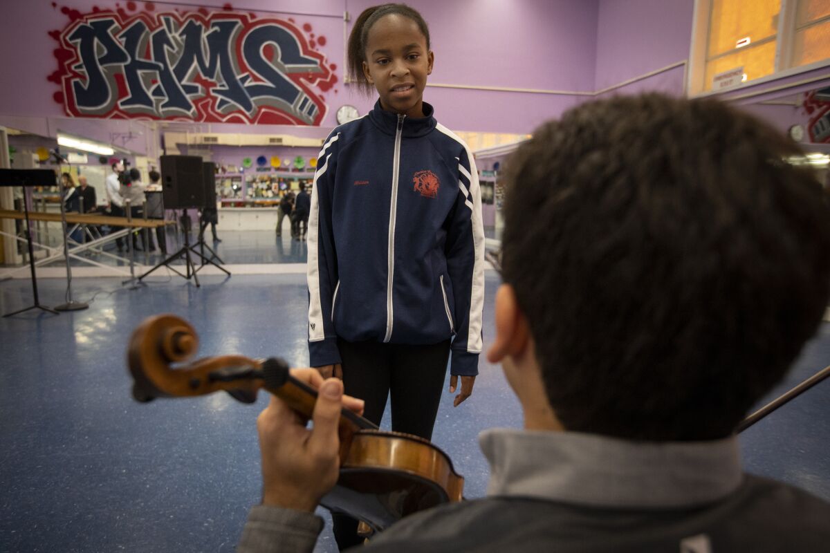 Joan-Kristen Gray, an eighth-grader at the time, speaks with Violins of Hope ambassador Niv Ashkenazi last November.