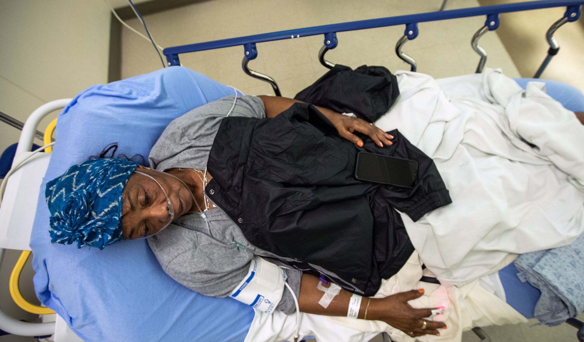 A person lying on a stretcher at the hospital