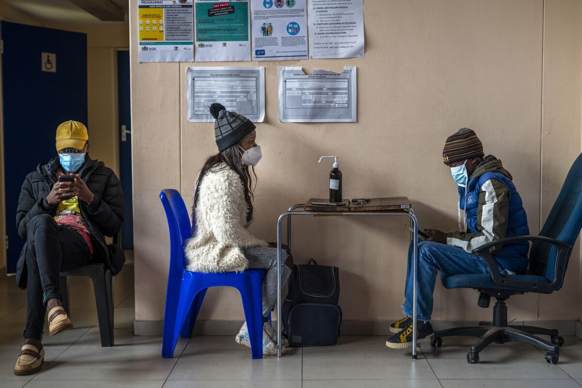 People register for COVID-19 vaccination at Soweto's Baragwanath hospital, South Africa, Monday Dec. 13, 2021. South Africa's 7-day rolling average of daily new COVID-19 cases has risen over the past two weeks from 7.60 new cases per 100,000 people on Nov. 28 to 32.71 new cases per 100,000 people on Dec. 12, according to Johns Hopkins University. In general, the new omicron cases have resulted in milder cases, with fewer hospitalizations and less severe cases requiring oxygen or intensive care. (AP Photo/Jerome Delay)